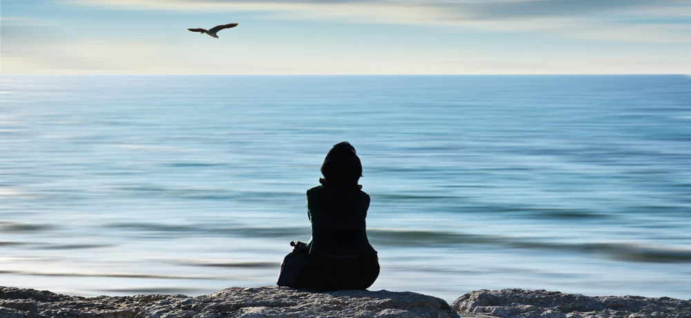 woman thinking by the sea